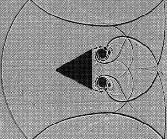 Shadowgraph of shock wave diffraction around a triangular obstacle taken in an air shock tube (Courtesy German-French Research Institute, St. Louis, ISL).